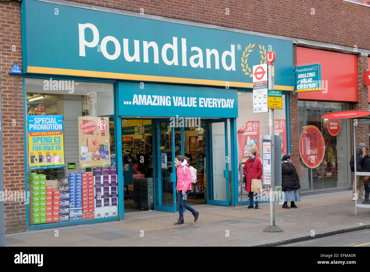 A woman walks past Poundland shop in Hammersmith, London Stock Photo
