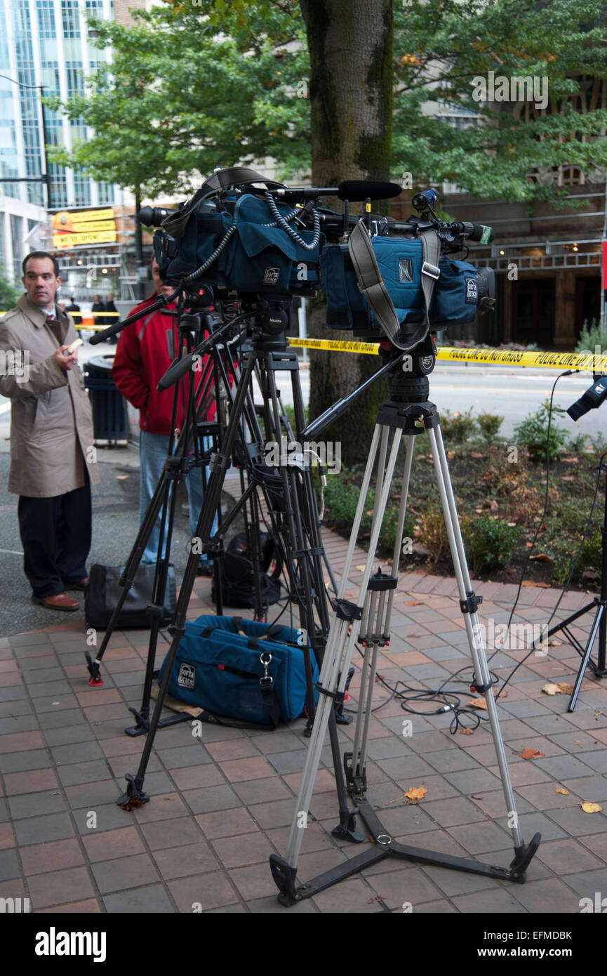 News cameraman and cameras set up on sidewalk, Vancouver, British