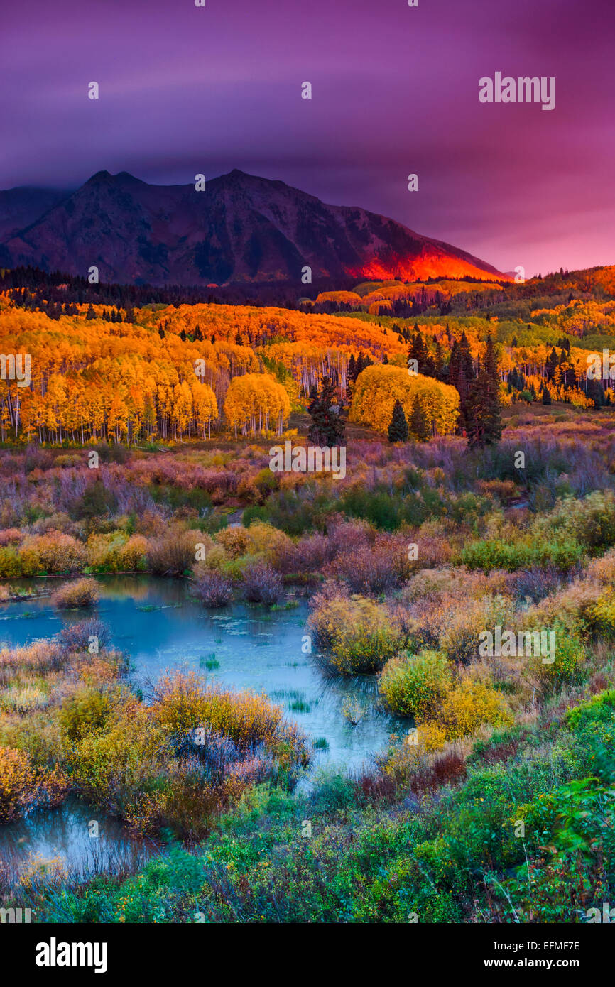 The sky is painted shades of pink as East Beckwith Mountain along Kebler Pass in Colorado is painted in the rich color of alpeng Stock Photo