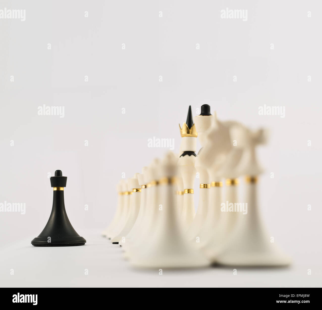 Black chess pawn opposite to white ones Stock Photo