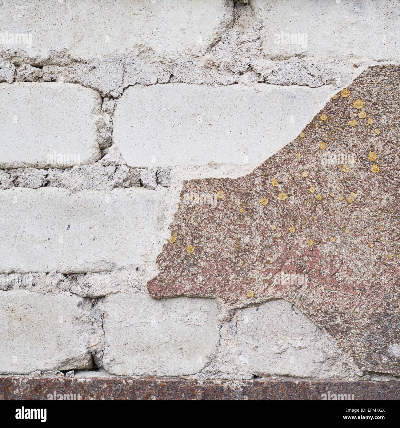 Brick wall with the whitewash falling off Stock Photo