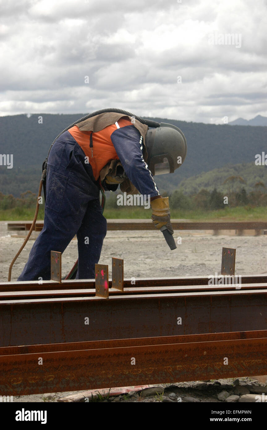 tradesman sandblasting beams for building project Stock Photo