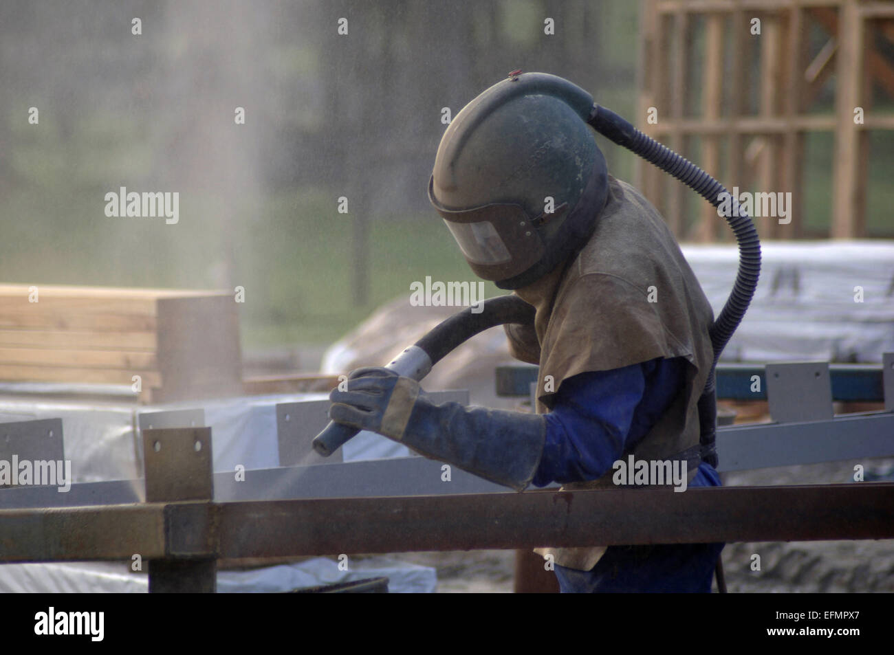 tradesman sandblasting beams for building project Stock Photo Alamy