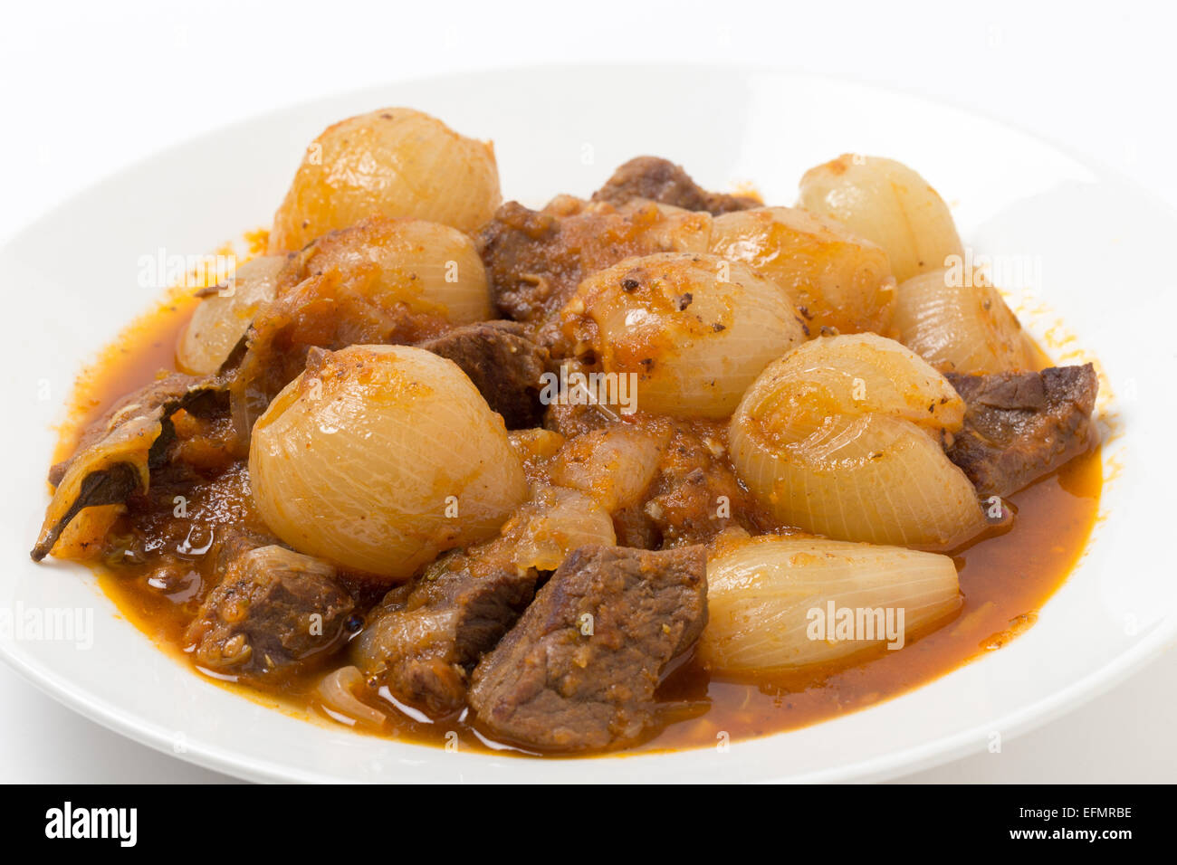 A bowl of traditional Greek stifado, a beef, onion and tomato stew, with garlic, herbes and