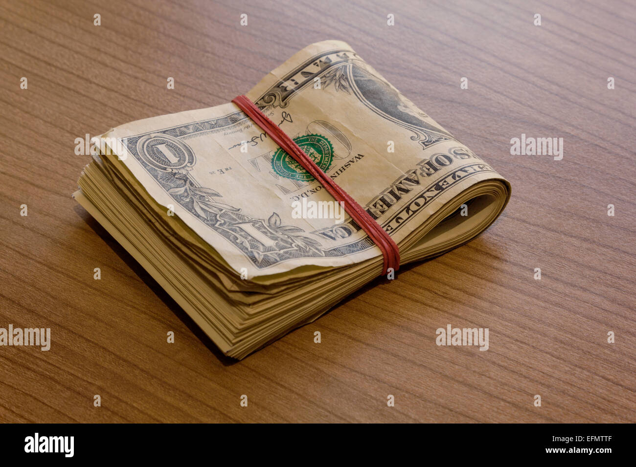 Bundle of dollar notes on a wooden table Stock Photo