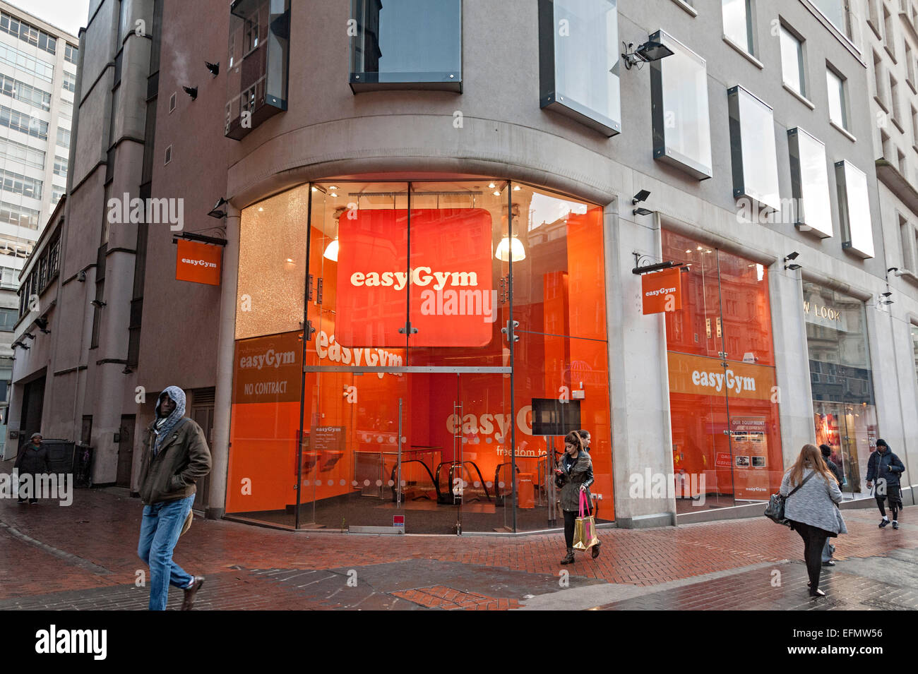 Easy gym birmingham central with orange coloured entrance Stock Photo Alamy
