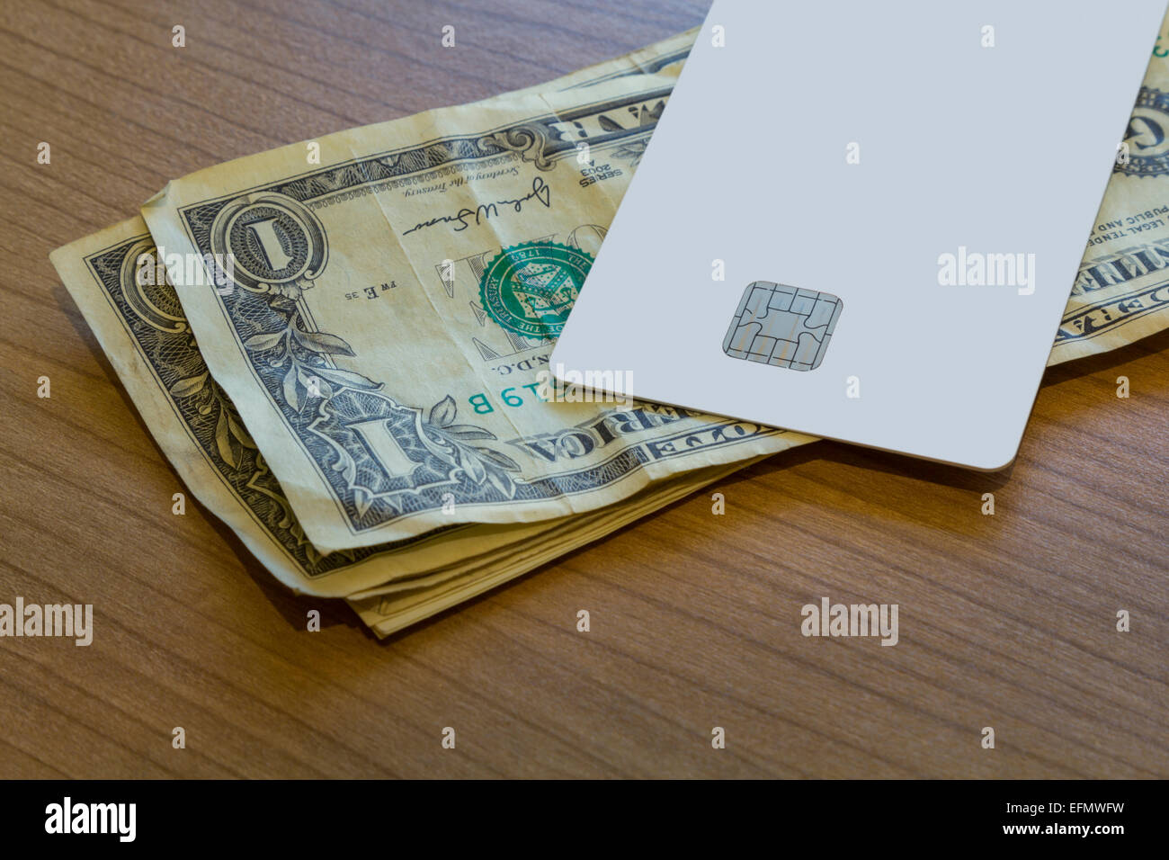 A Blank white Credit or Debit Card and a couple of dollar notes on a ...