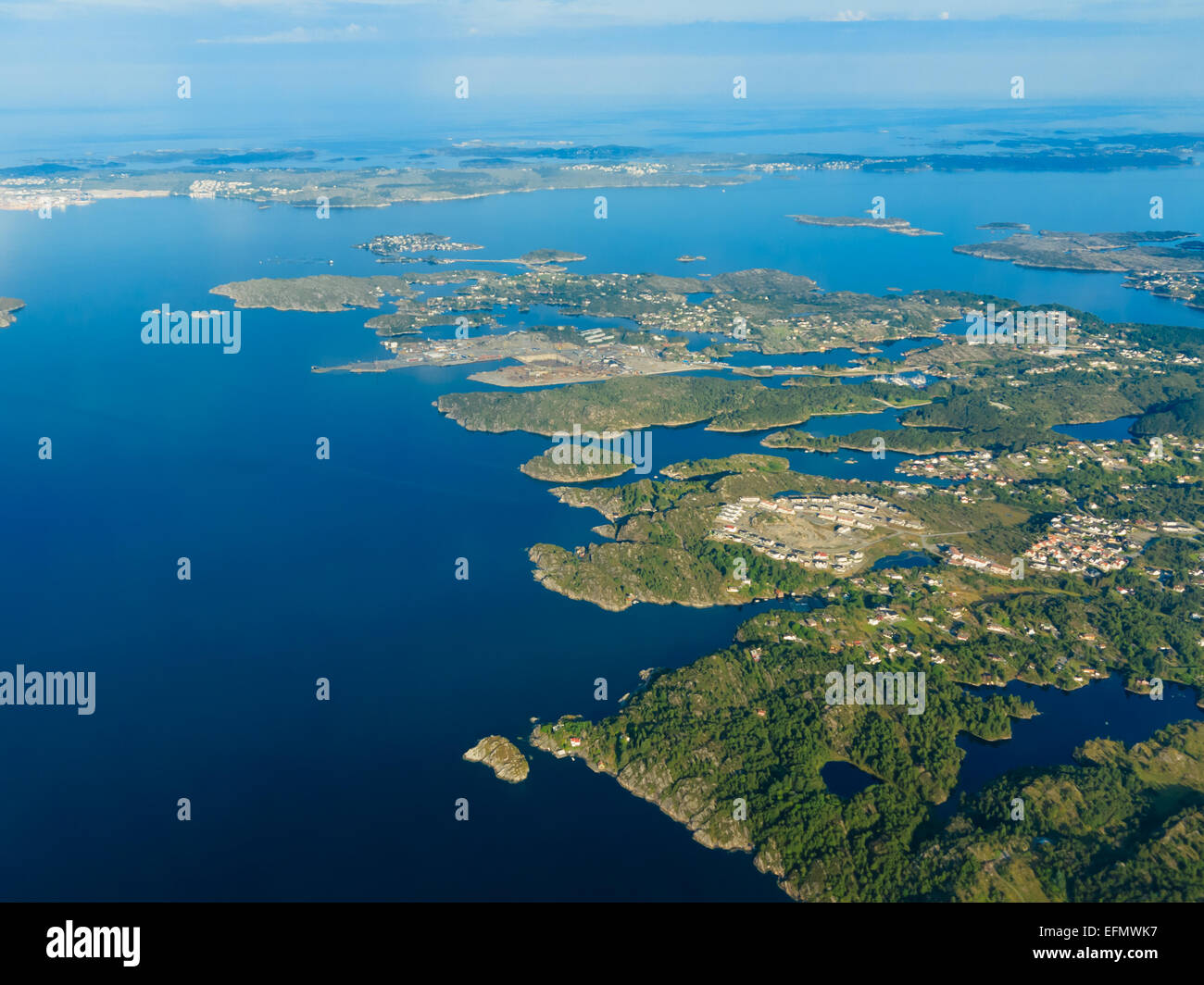 Birds eye. View from window of plane airplane flying over fjords Norway