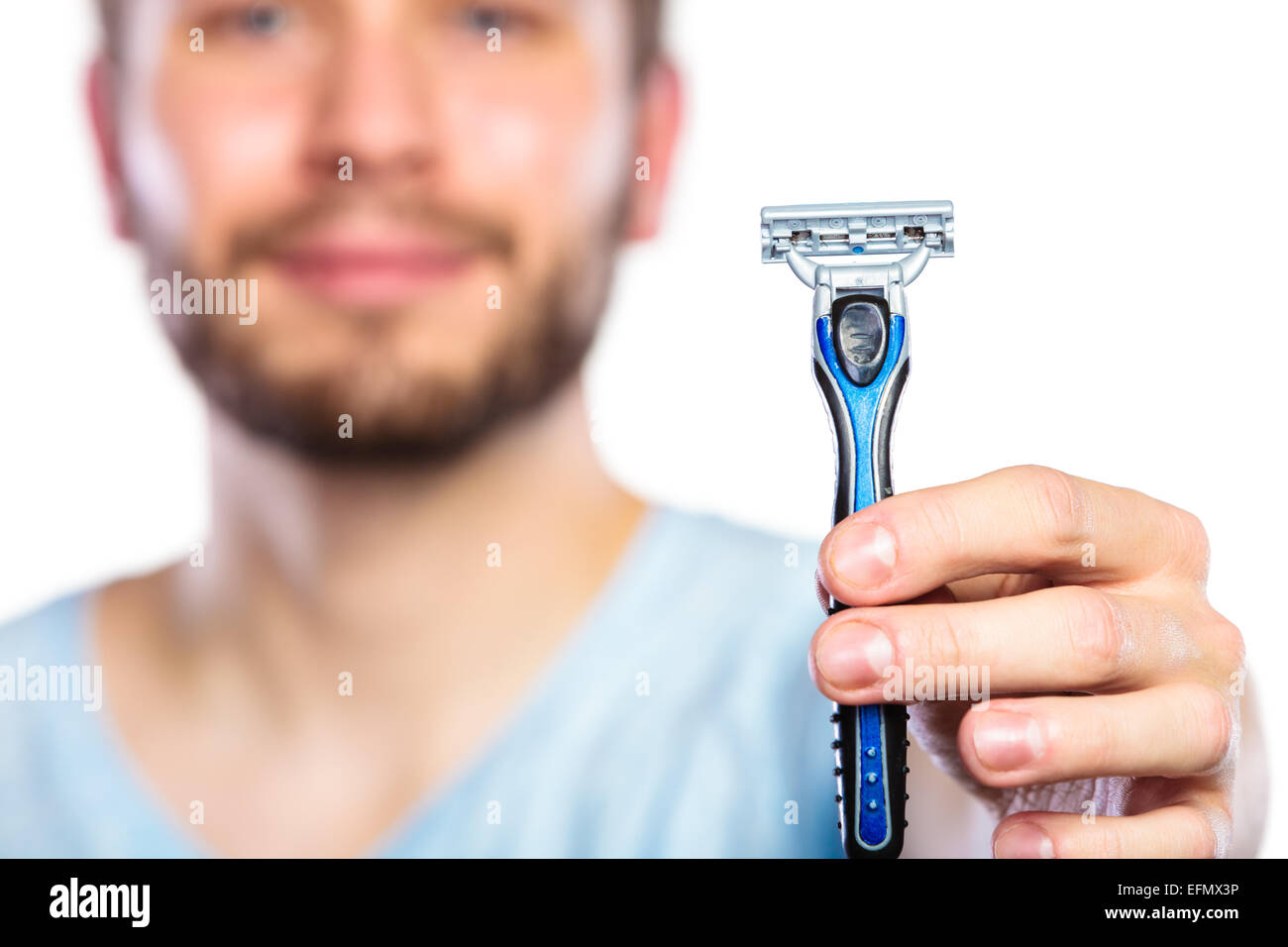 Young man guy with beard showing disposable blue razor blade, studio ...