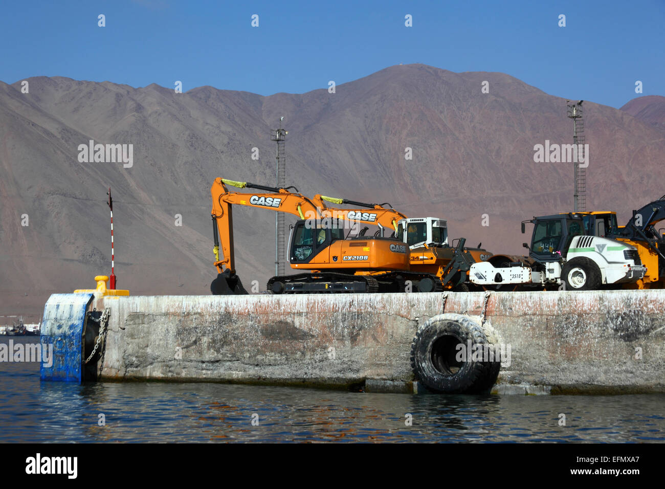Newly imported excavators and tractors on quay in port, Iquique, Tarapaca  Region, Chile Stock Photo