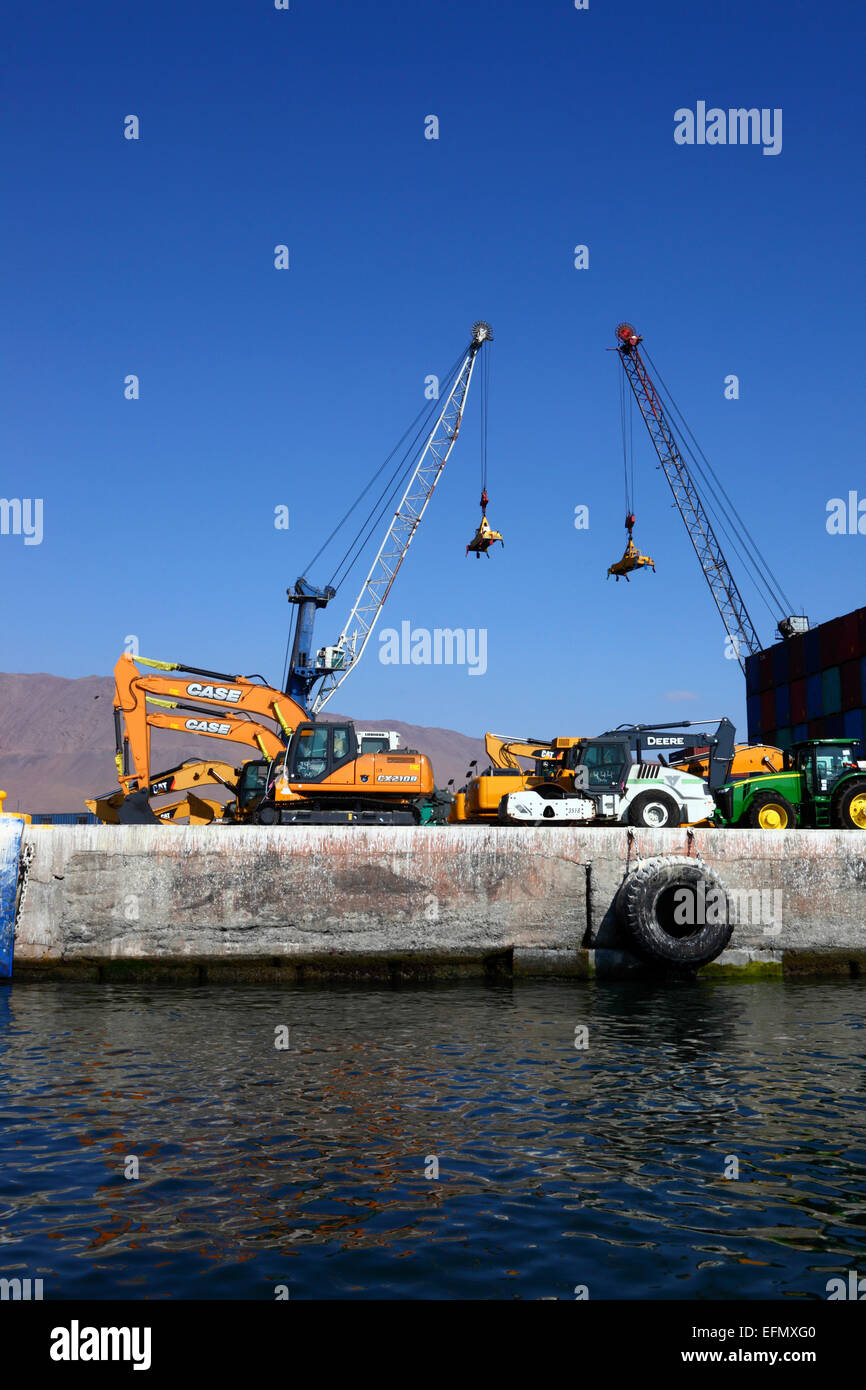 Newly imported excavators and tractors on quay in port, Iquique, Tarapaca  Region, Chile Stock Photo