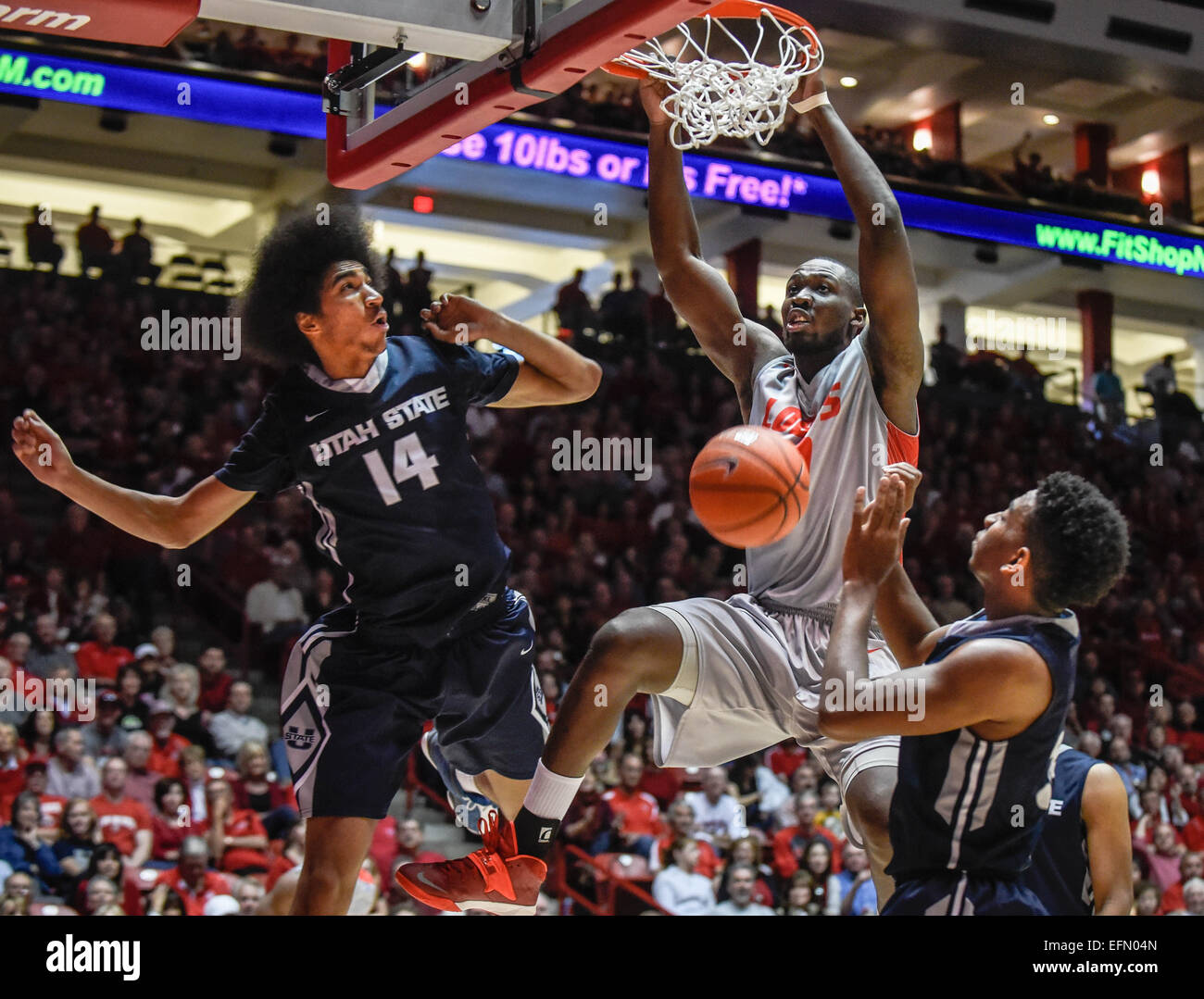 Albuquerque, New Mexico, USA. 7th Feb, 2015. Roberto E. Rosales.UNM's J.J. N'Ganga(Cq), center, dunks over Utah State's Jalen Moore(Cq), left, and Chris Smith(Cq), right Saturday afternoon at the Pit. Utah State defeated the Lobos 63 to 60. Albuquerque, New Mexico © Roberto E. Rosales/Albuquerque Journal/ZUMA Wire/Alamy Live News Stock Photo
