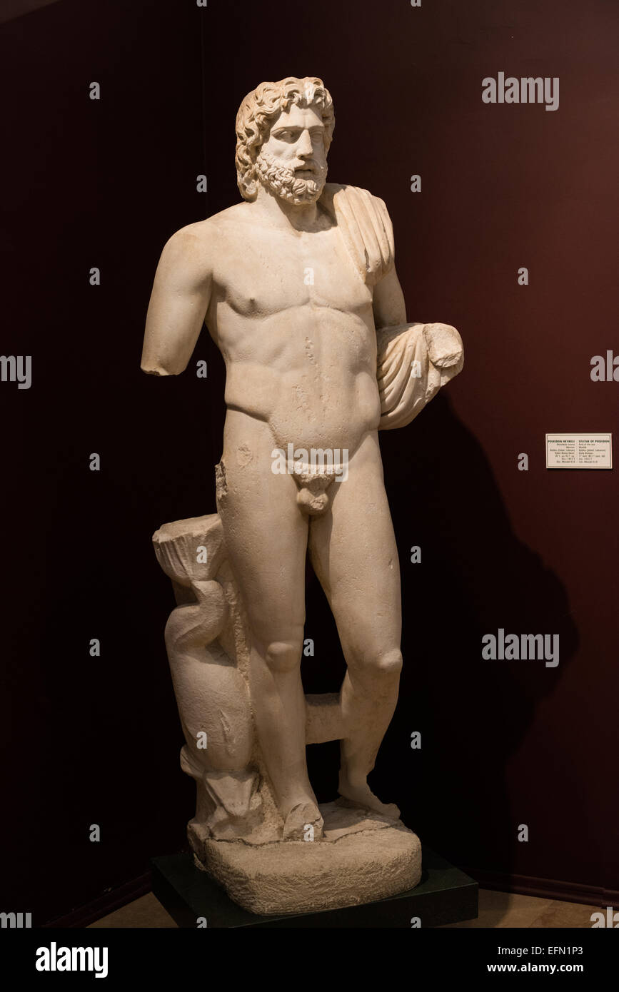 ISTANBUL, Turkey / Türkiye — Statue of Poseidon (God of the sea), made of marble, from Lebanon, and dating to around the 1st century BC to the 1st century AD, on display in the main building of the Istanbul Archaeology Museums. The Istanbul Archaeology Museums, housed in three buildings in what was originally the gardens of the Topkapi Palace in Istanbul, Turkey, holds over 1 million artifacts relating to Islamic art, historical archeology of the Middle East and Europe (as well as Turkey), and a building devoted to the ancient orient. Stock Photo