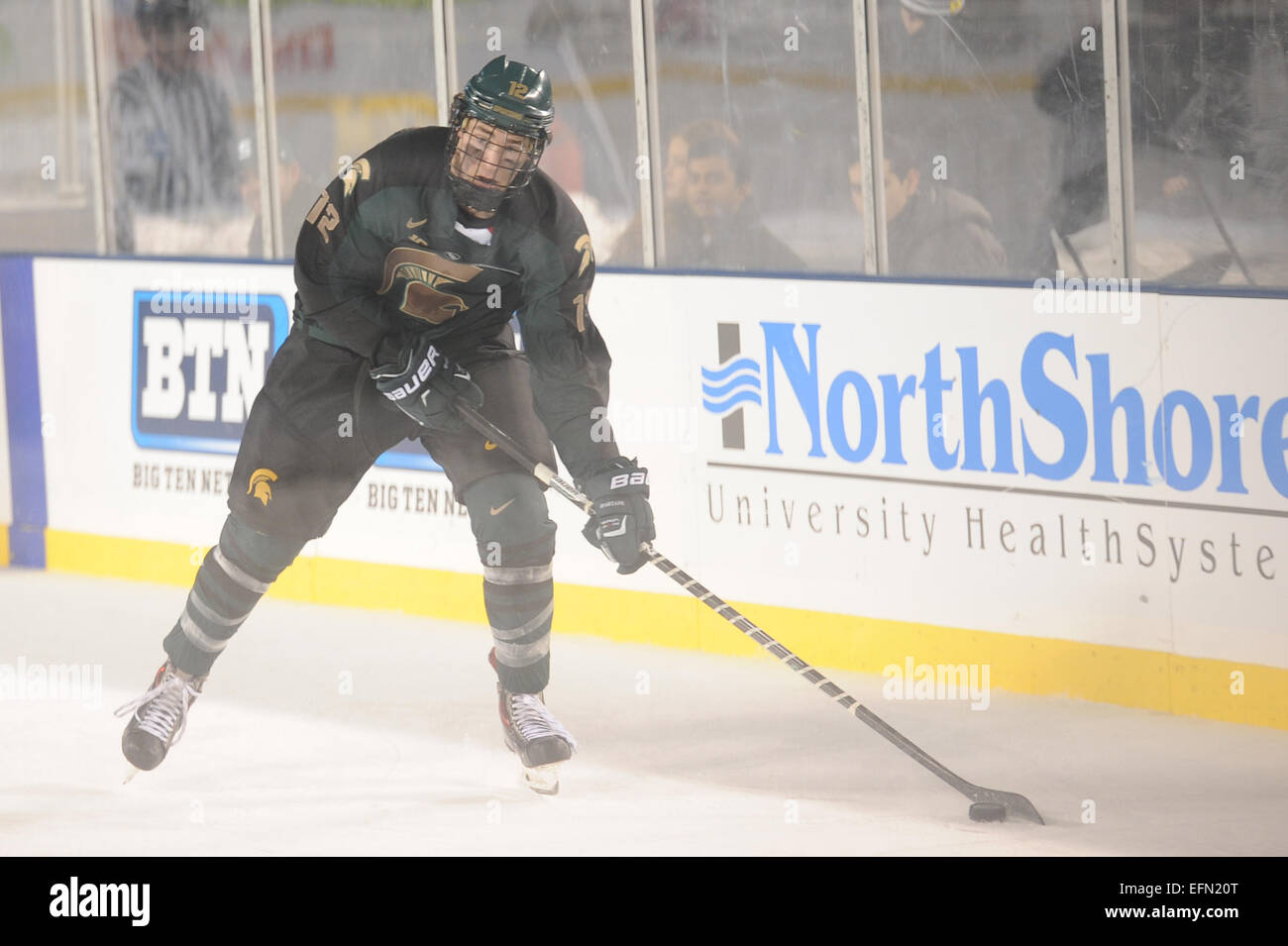 Chicago, IL, USA. 7th Feb, 2015. Michigan State's Brent Darnell (25)  attempts to fight Michigan's Andrew Copp (9) during the Coyote Logistics  Hockey City Classic NCAA hockey game between the Michigan State
