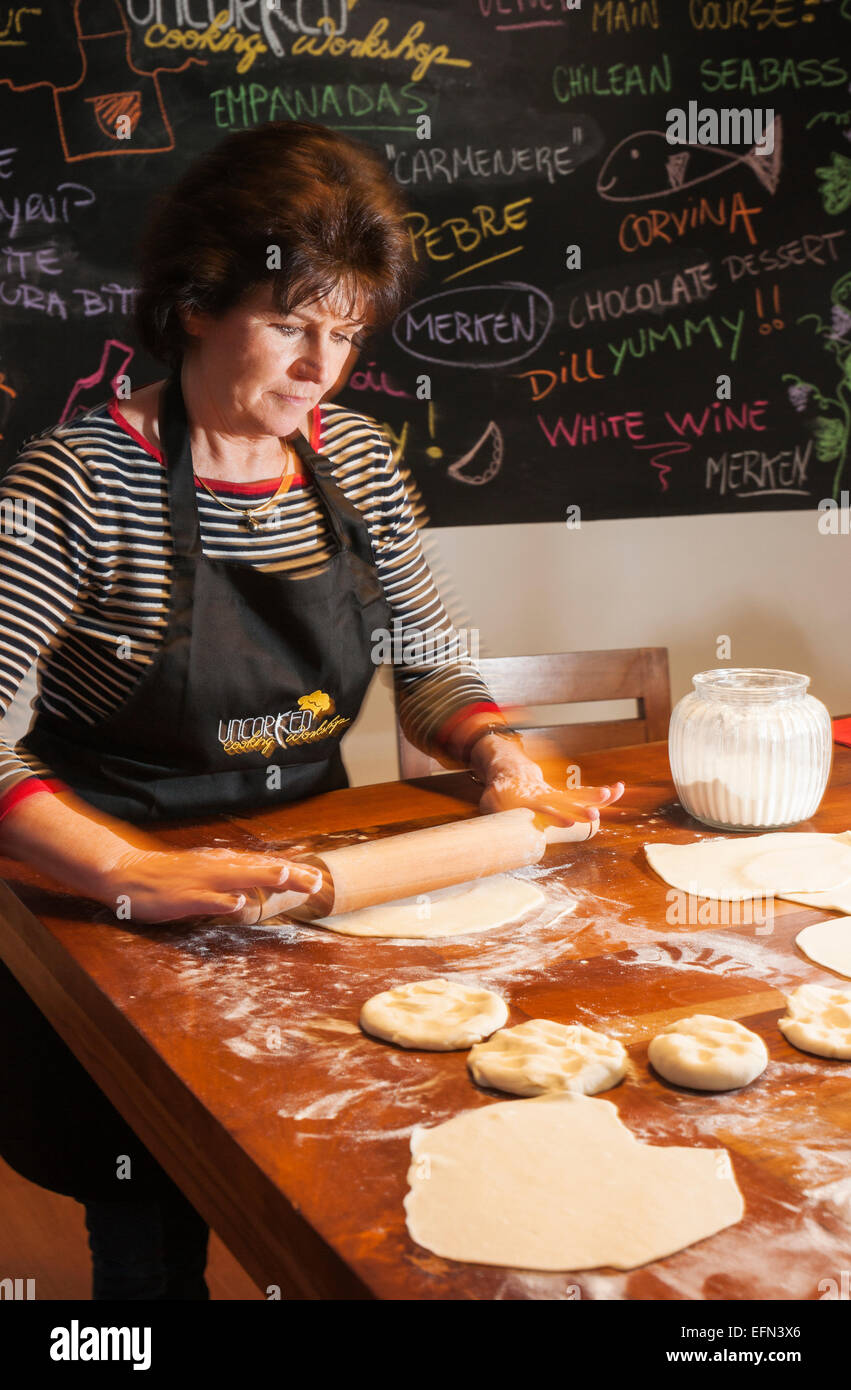 Woman rolling dough for empanadas, Cooking class, Bellavista district, Santiago, Chile, South America Stock Photo