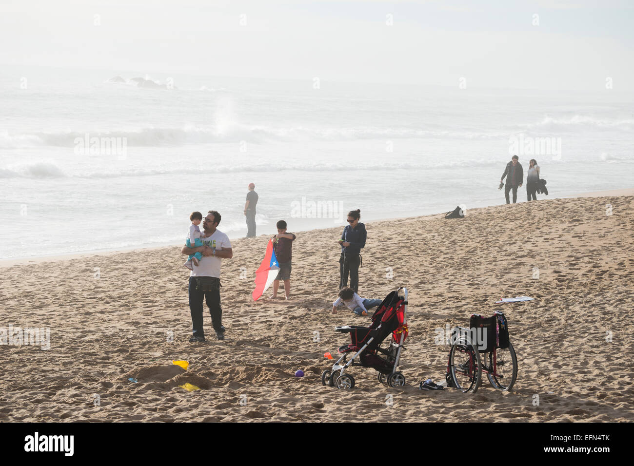 Local families enjoying the beach on a foggy day, Vina de Mar, Chile, South America Stock Photo