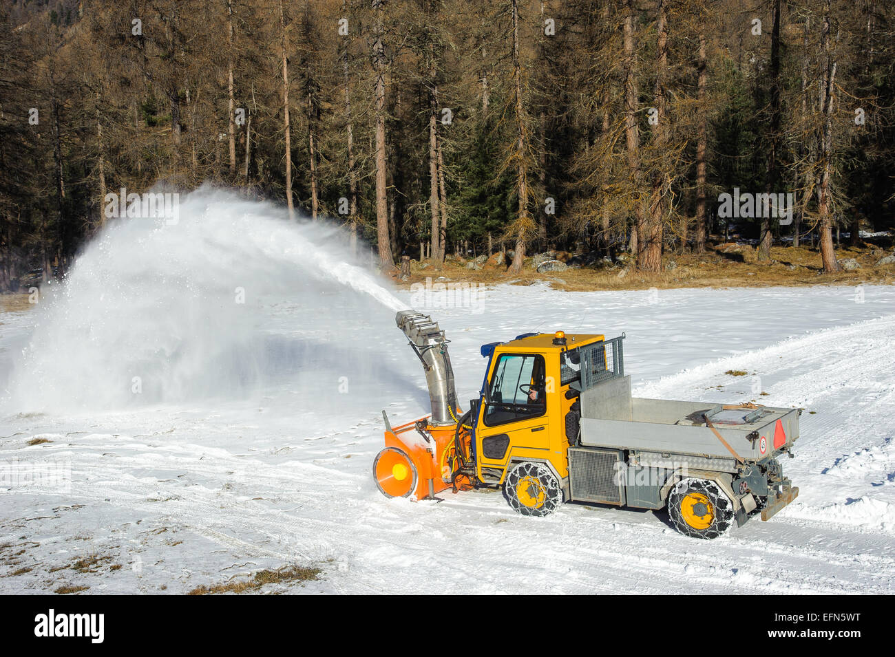 pickup truck with snowblower removing snow by  road Stock Photo
