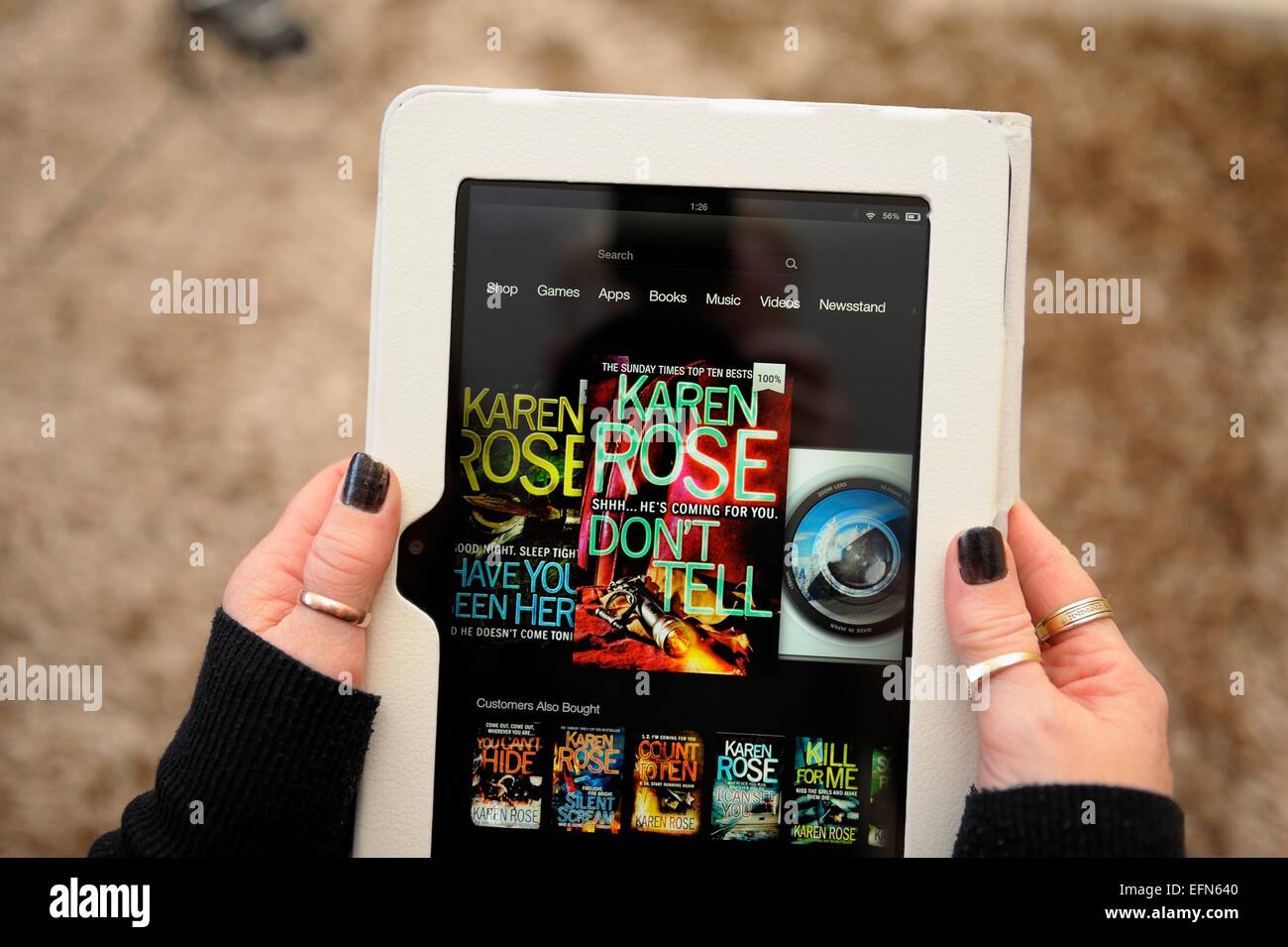 A kindle fire being used to buy a book to read England UK Stock Photo