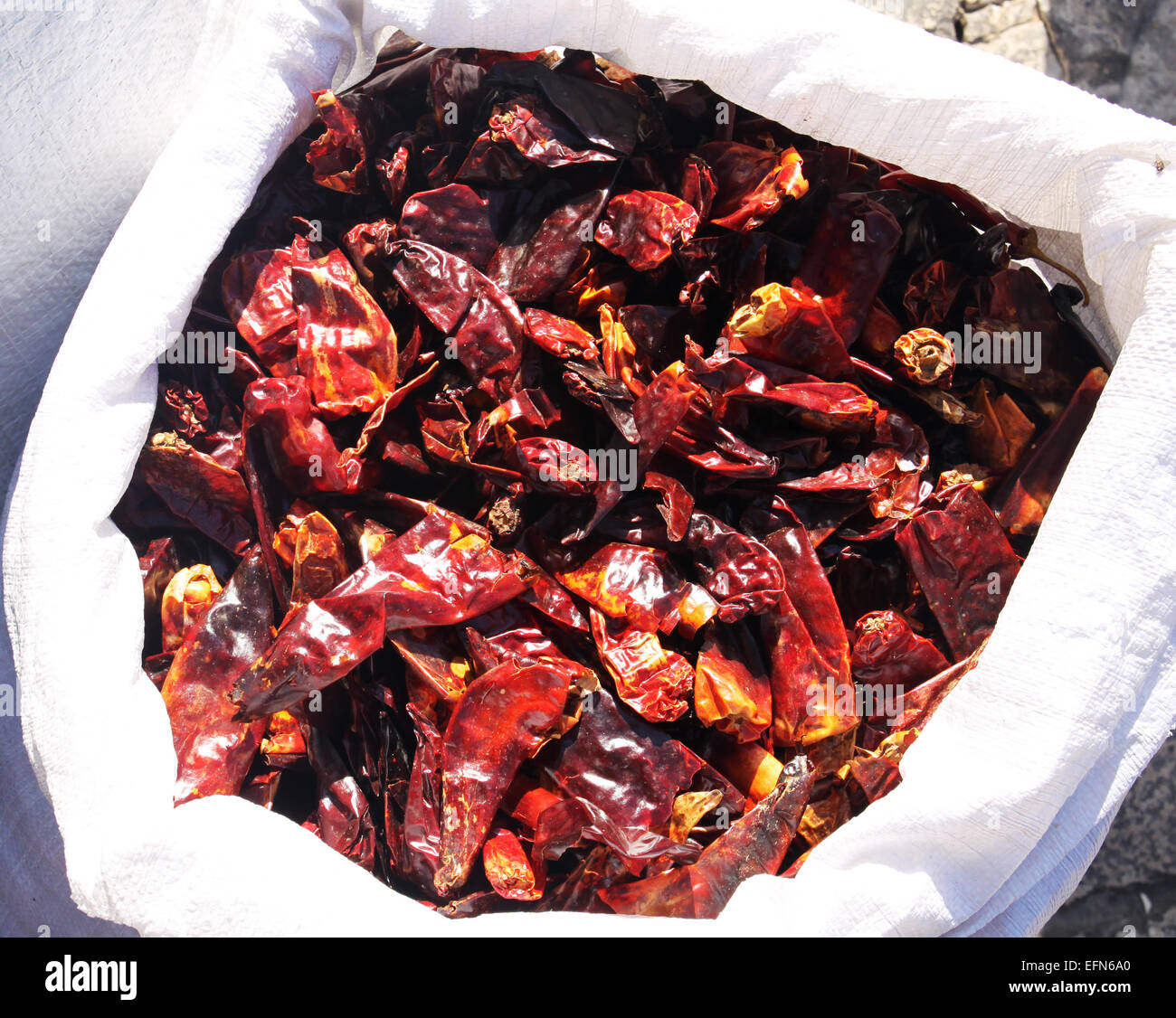 A white bag full of dry red papers Stock Photo - Alamy