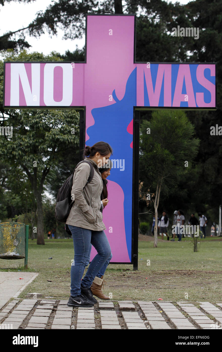 Quito, Ecuador. 7th Feb, 2015. Women walk in front of a cross that is part of the campaign 'No More Pink Crosses', in Quito, capital of Ecuador, on Feb. 7, 2015. According to local press information, the campaign aims to take the message against femicide to schools, colleges, universities and meeting places in Quito City. © Santiago Armas/Xinhua/Alamy Live News Stock Photo
