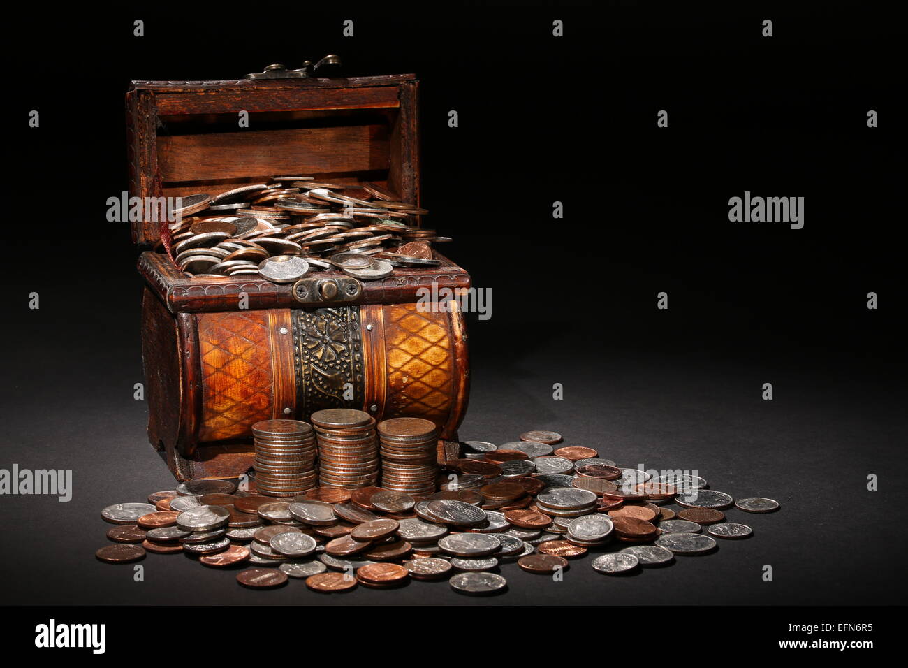 Open treasure chest with gold coins isolated on white Stock Photo