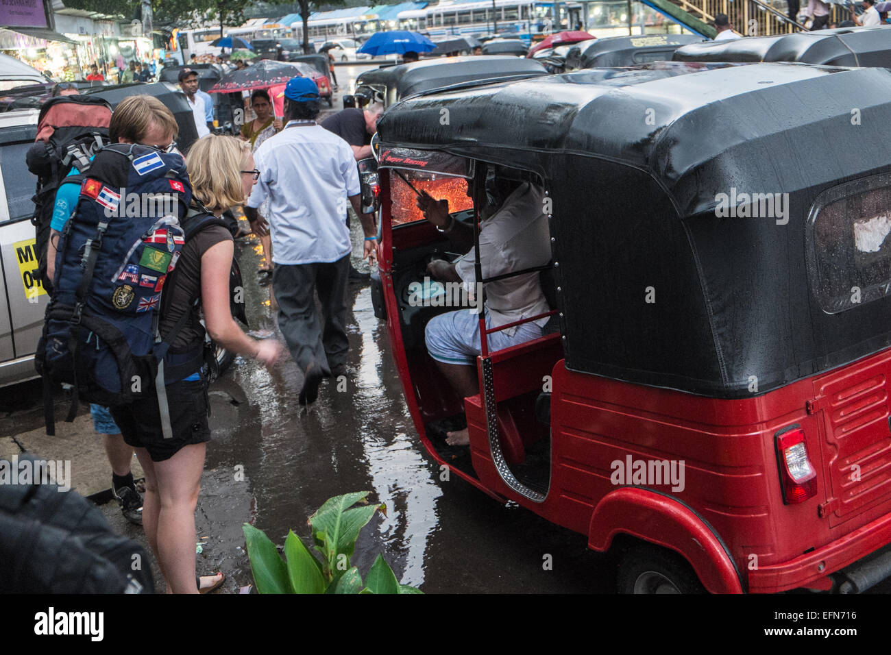 Scandinavian tourists backpackers negotiate and then board an auto ...