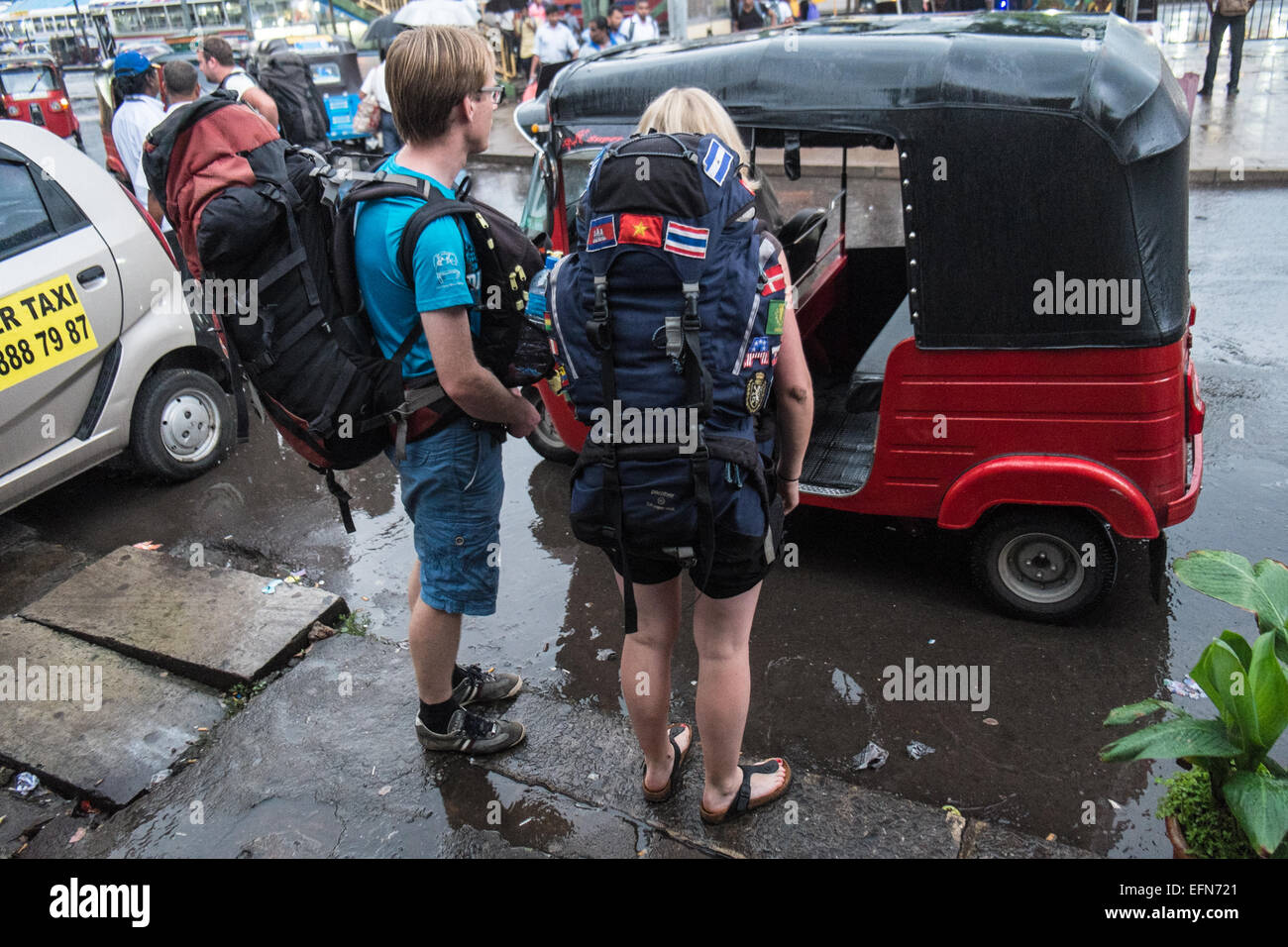 Scandinavian tourists backpackers negotiate and then board an auto ...