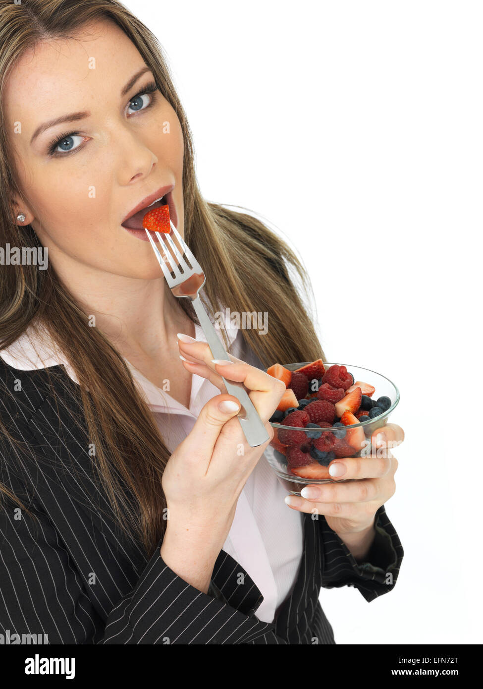 Young Attractive Business Woman Holding a Bowl of Fresh Mixed Berries Stock Photo