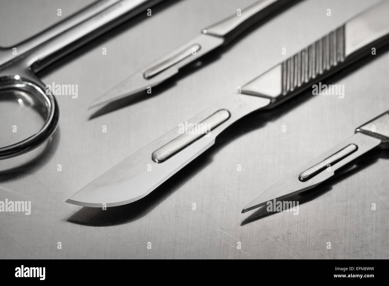 razor sharp surgical stainless steel blade on scalpel used for clinical operations in clean sterile environment Stock Photo