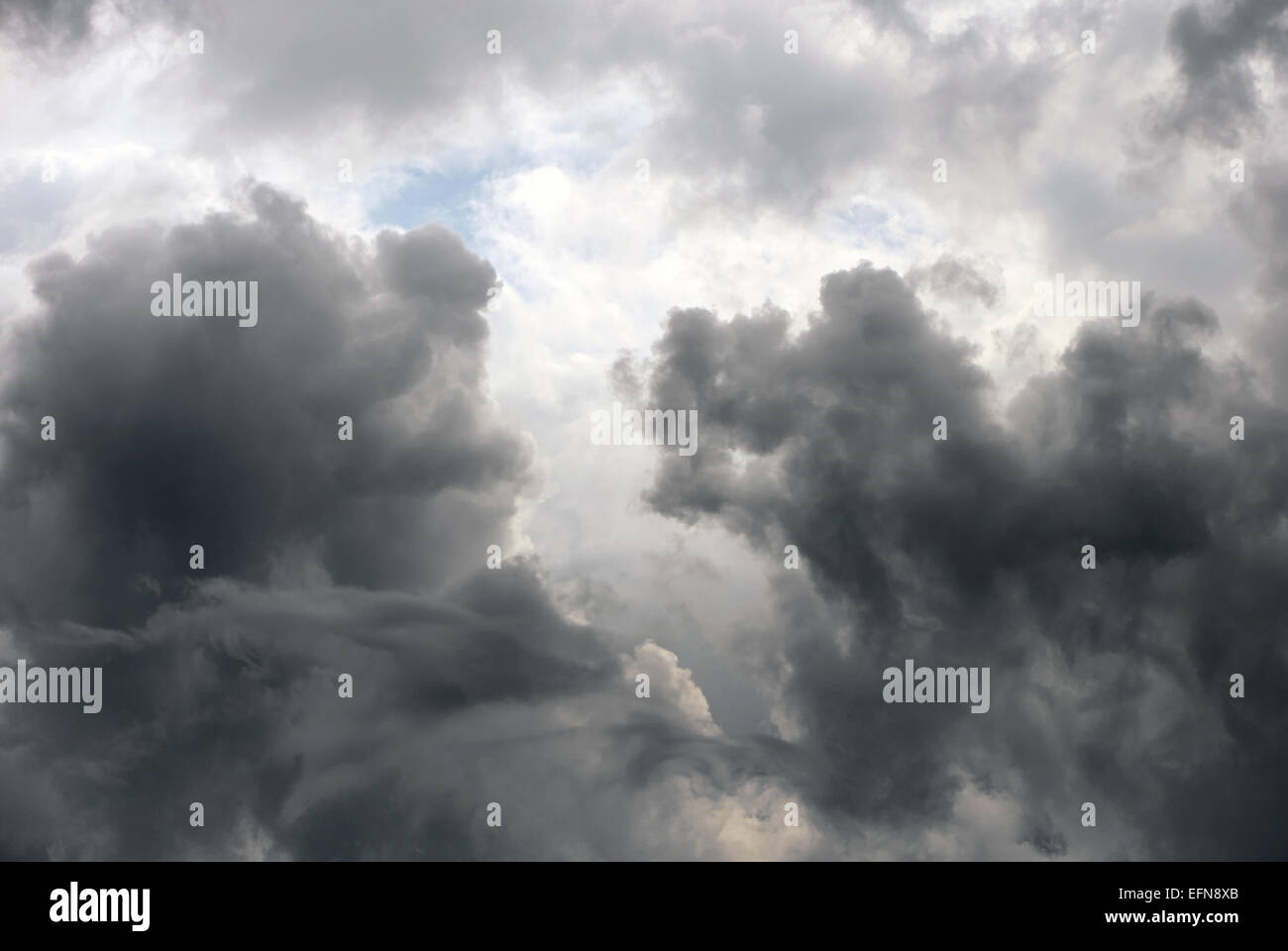Deep gray clouds in and blue sky behind Stock Photo