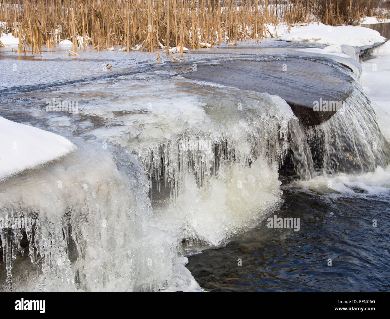 Small waterfall or weir, even more decorative in winter, partially ...