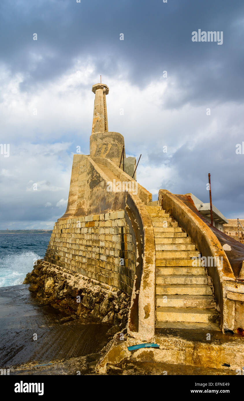 Old lighthouse at Marfa Point, next to the ferry terminal - Cirkewwa, Malta. Stock Photo