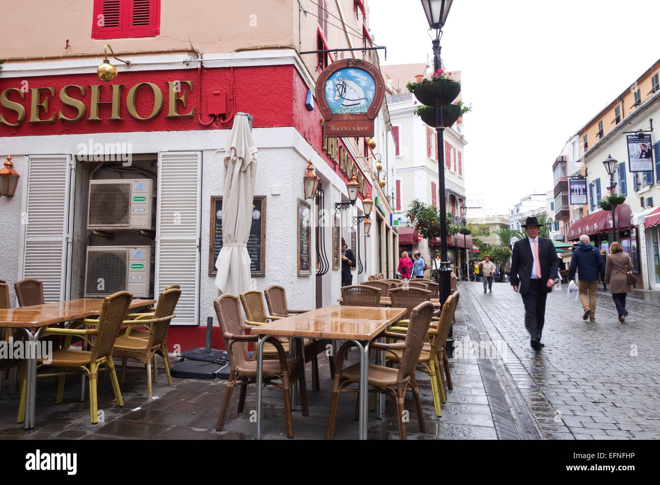 Rainy Main Street with horseshoe Bar in Gibraltar, overseas British