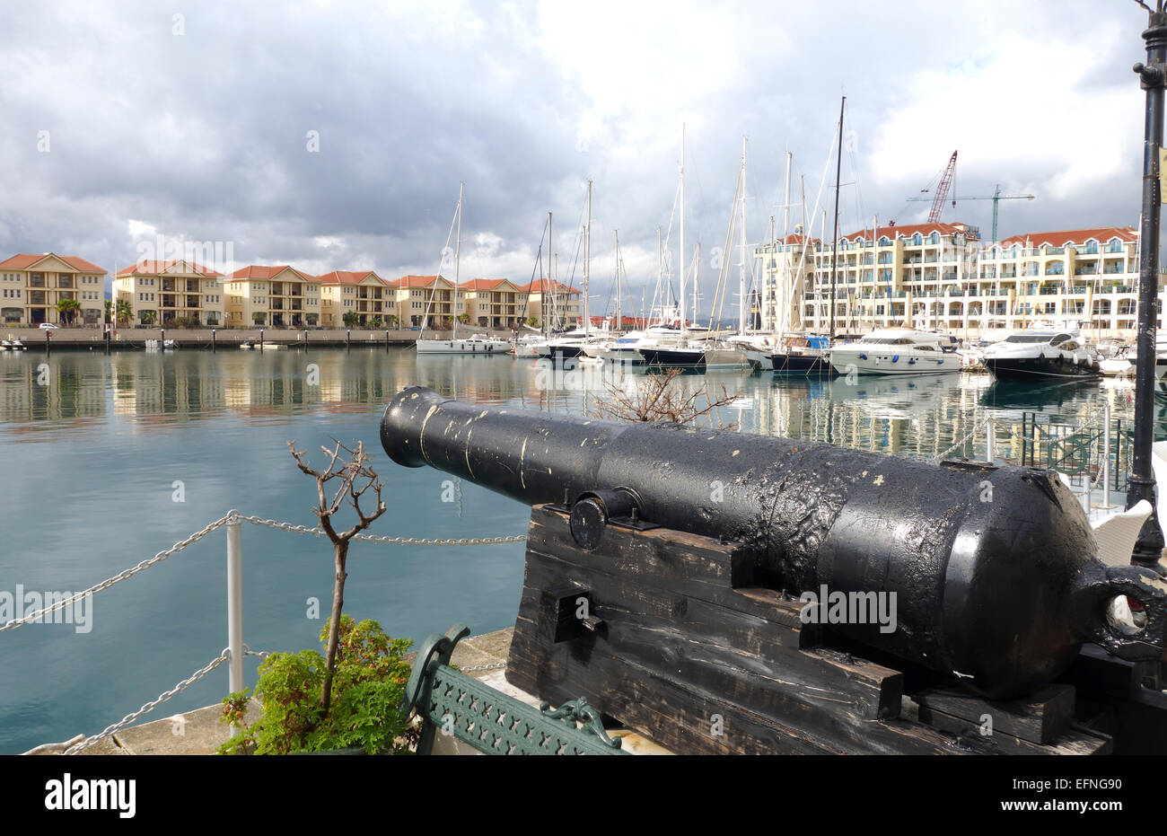 Cannon, Townhouses, Yachts and boats at Queensway Quay Marina, Gibraltar, United Kingdom, UK. Stock Photo