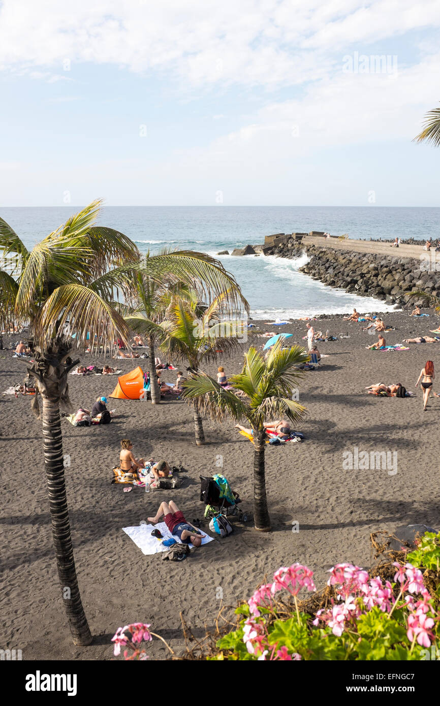 Tourists sunbathing on Playa Jardin beach, Puerto de la Cruz, Tenerife Stock Photo