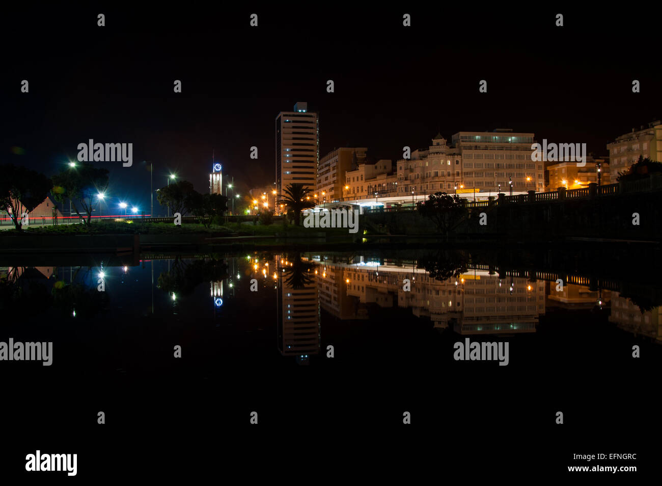 Buildings reflected in a water mirror at night in Figueira da Foz, Portugal Stock Photo