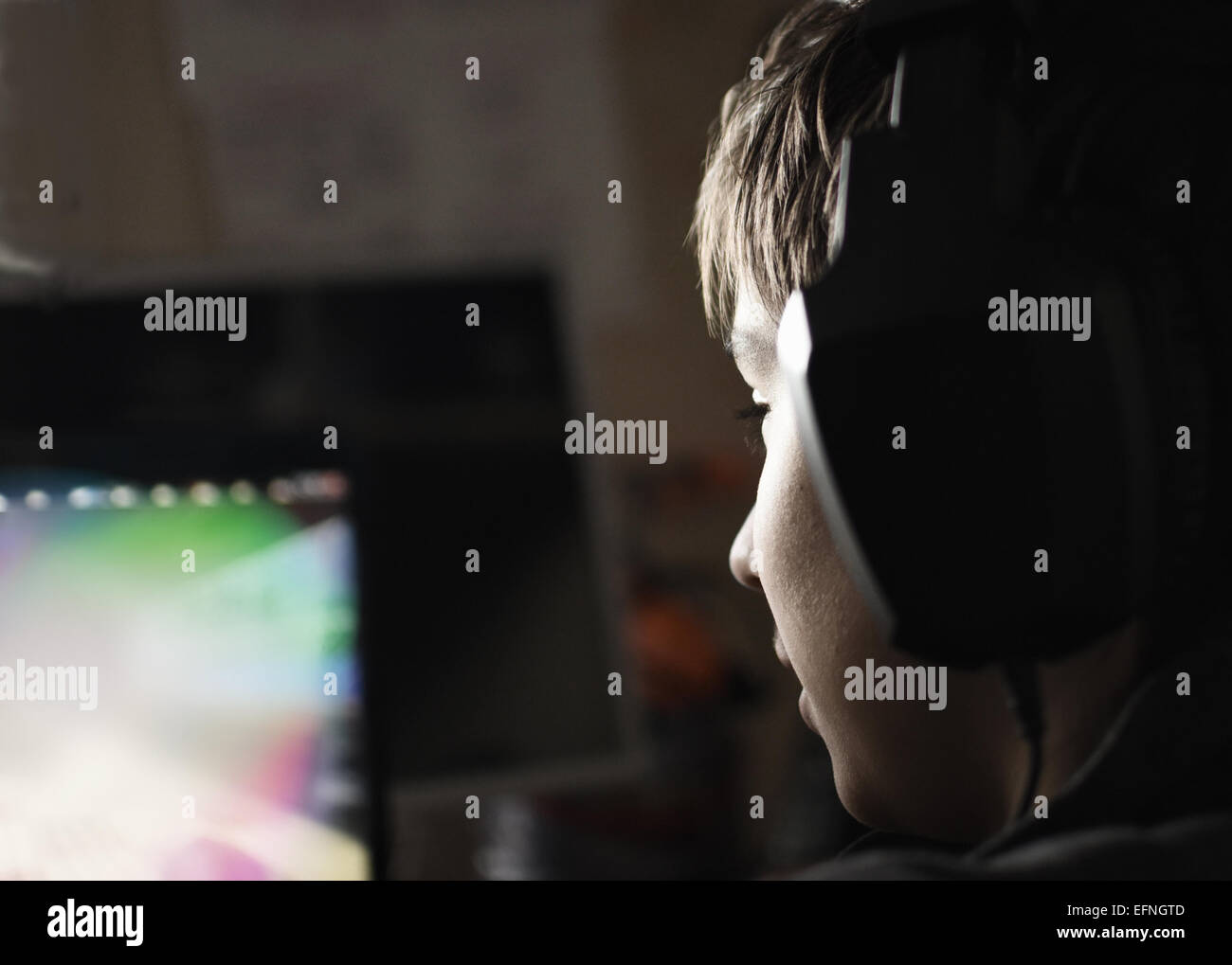 Teen boy with headphones and laptop Stock Photo