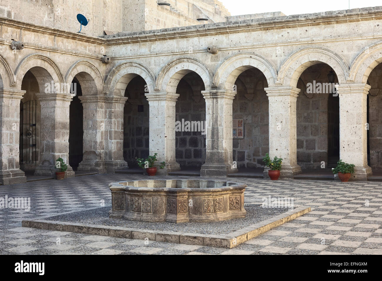Patio with fountain surrounded by an archway made of sillar (volcanic rock) in the Cloisters of the Company in Arequipa, Peru Stock Photo