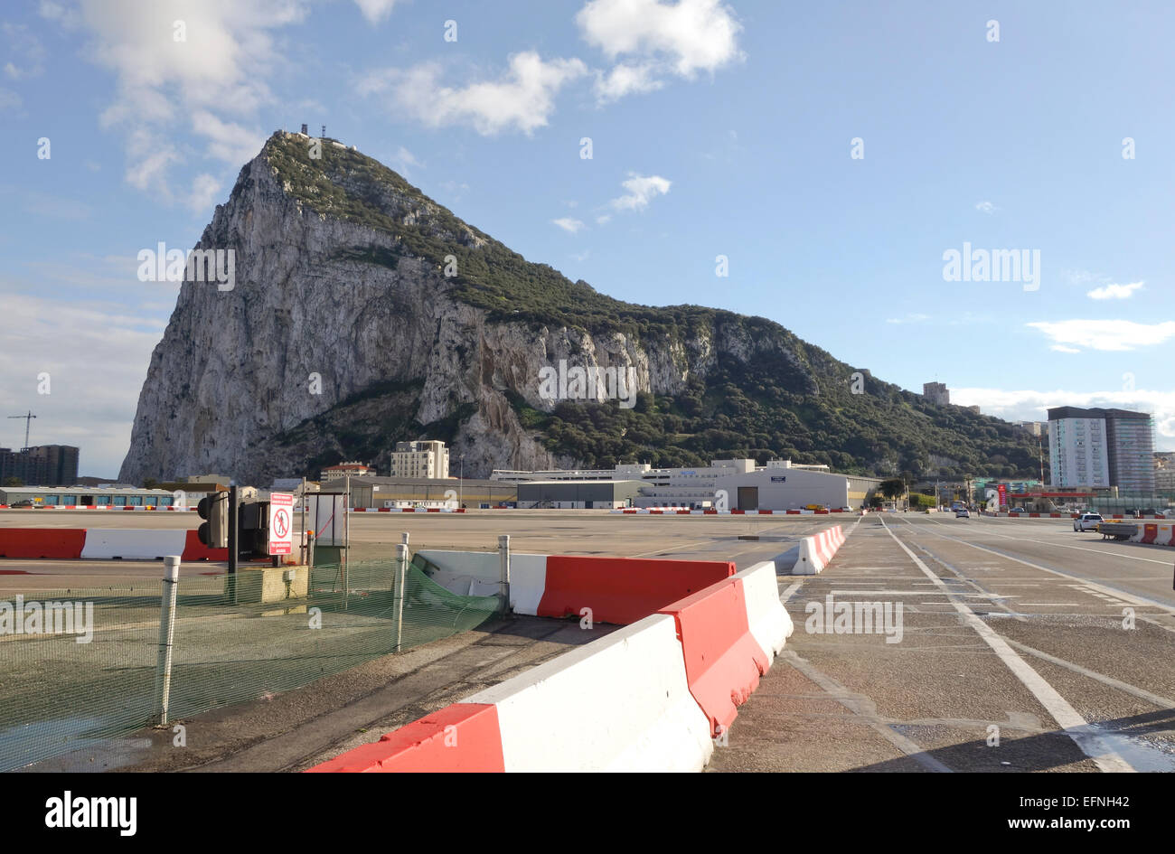 Gibraltar rock. Cars and pedestrians cross the runway of Gibraltar airport at the border of Spain to enter Gibraltar. Uk. United Kingdom. Stock Photo