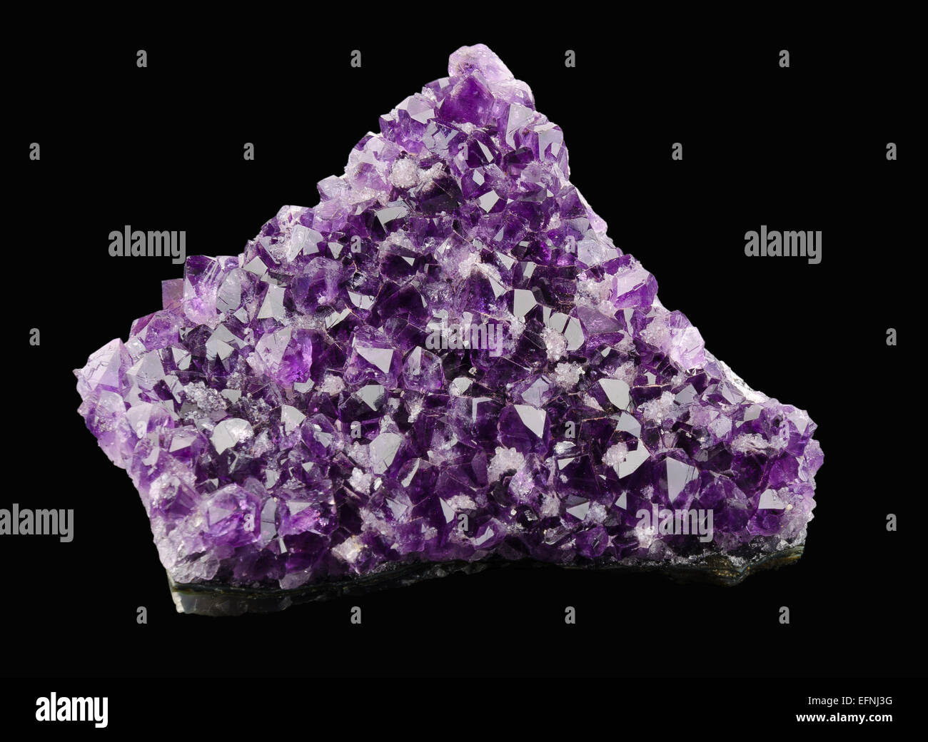 Amethyst on black background, a violet variety of quartz, often used in jewelry. Silica, silicon dioxide, SiO2. Stock Photo