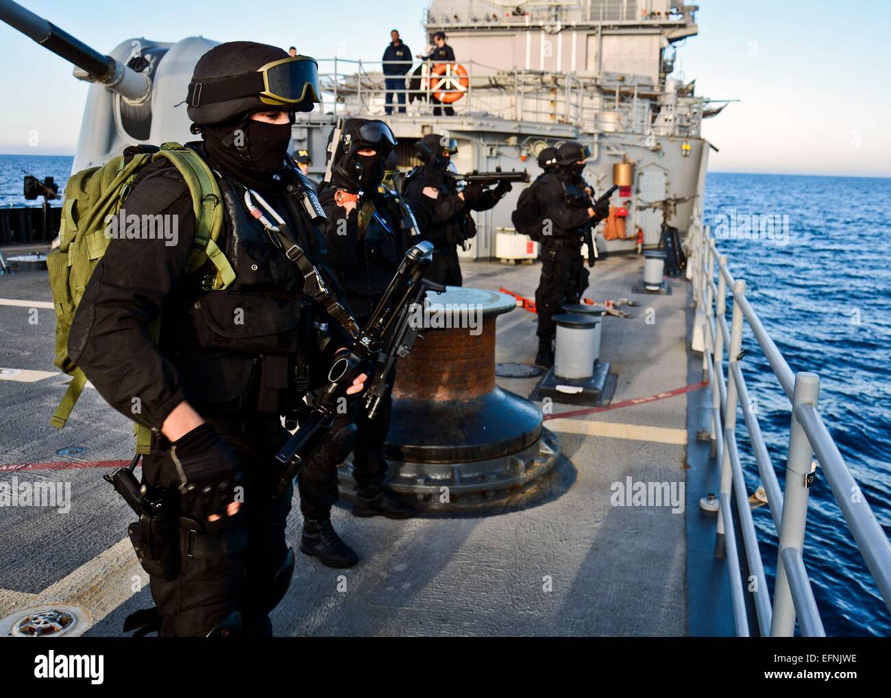 Portuguese Navy commandos in black uniforms prepare for visit, board, search and seizure operation team check weapons part of NATO exercise Noble Justification aboard the USS Leyte Gulf October 17, 2014 in the Alboran Sea. Stock Photo