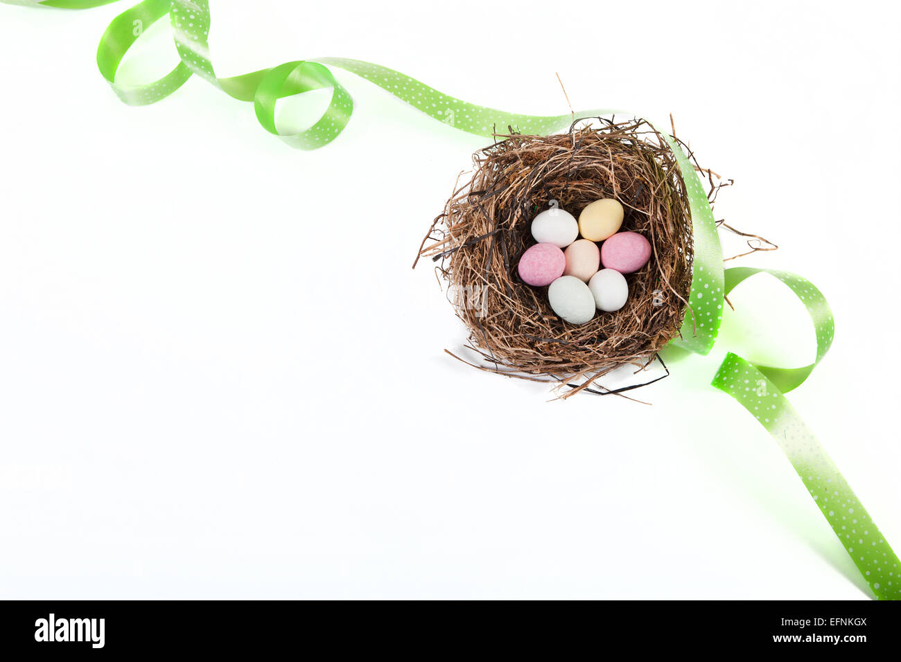 Easter basket with green ribbon and white background Stock Photo