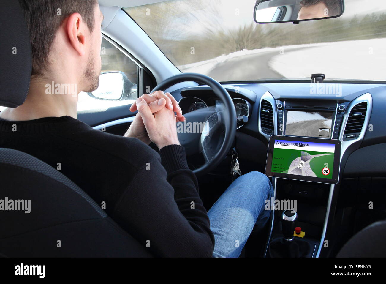 A man in a Autonomous driving  test vehicle Stock Photo