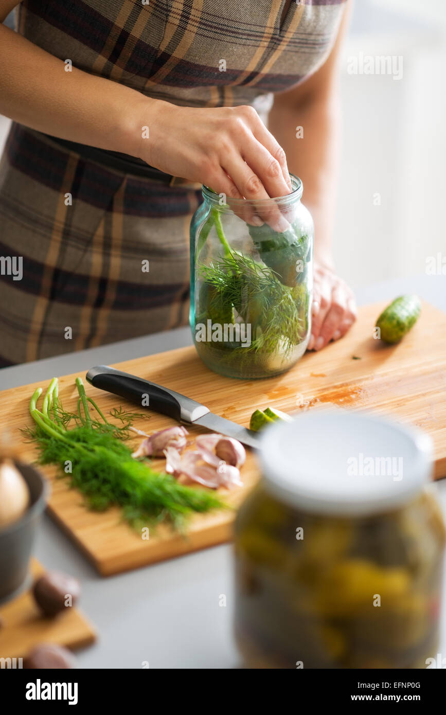 Closeup on young housewife pickling cucumbers Stock Photo