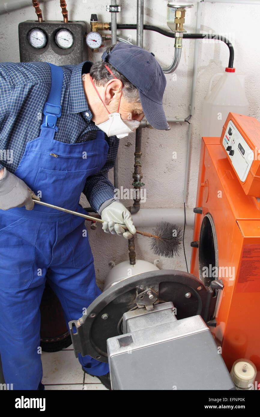 A specialist doing Boiler cleaning Stock Photo