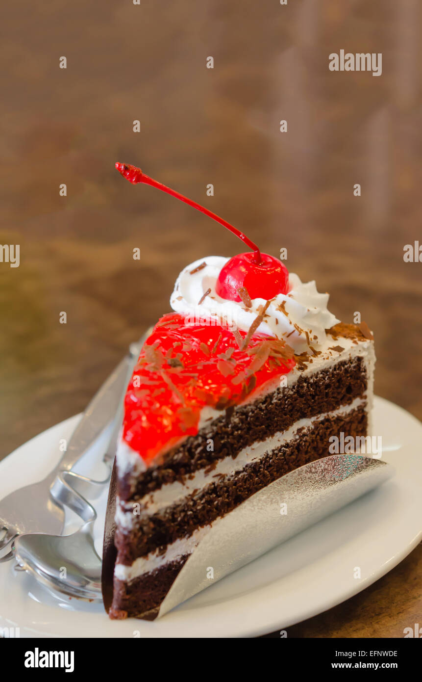 Piece of fruit cake with red cherry Stock Photo