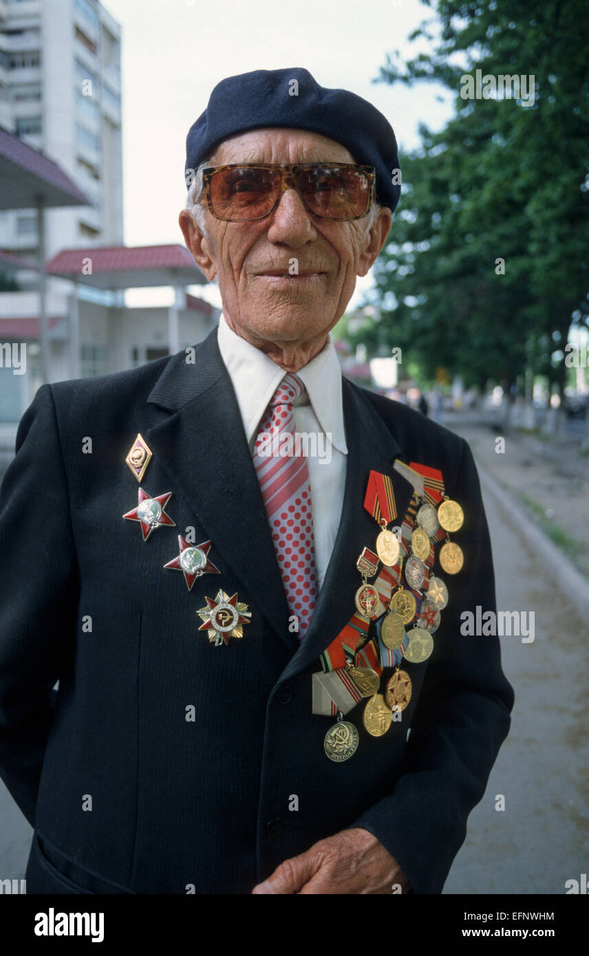 An elderly war veteran wears his medals in a street of Bishkek, Kyrgyz Republic, Central Asia Stock Photo