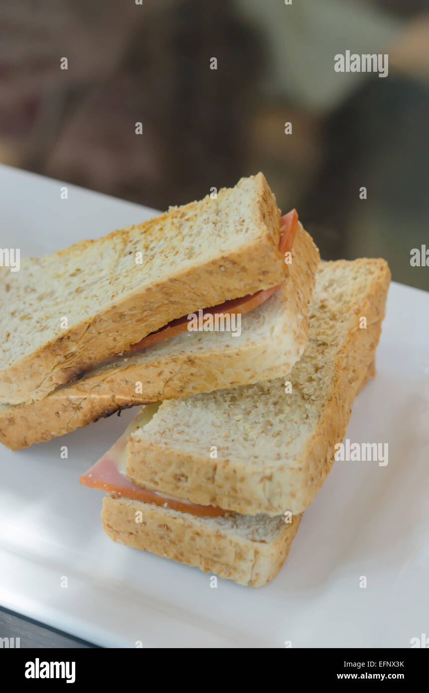 close up toasted sandwich with ham and cheese on dish Stock Photo