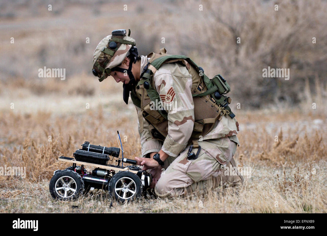 US Air Force Staff Sgt. Lilly Smith attaches C-4 explosive to the front of a remote controlled vehicle used by explosive ordnance disposal personnel to detonate roadside improvised explosive devices during training at Hill Air Force Base November 10, 2004 in Ogden, Utah. Stock Photo