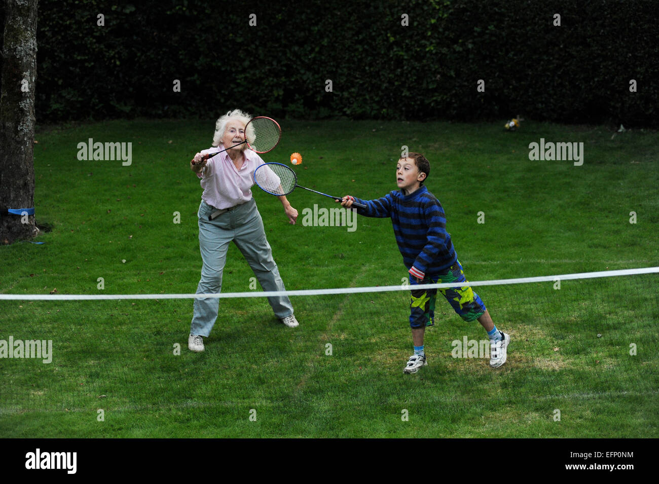 grandparents playing Badminton with their Grandson in their garden in North yorkshire. england uk Stock Photo